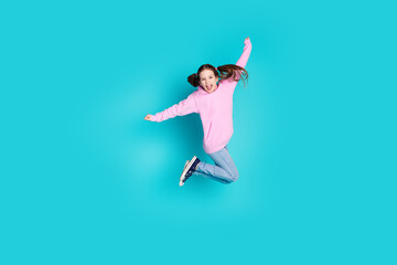 Full size photo of pretty little girl jump have fun wear trendy pink outfit isolated on aquamarine color background