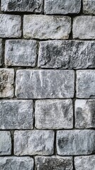 Obraz premium Weathered gray stone wall texture, showcasing rugged rectangular blocks with rough surfaces and uneven edges, creating a timeless and durable facade.