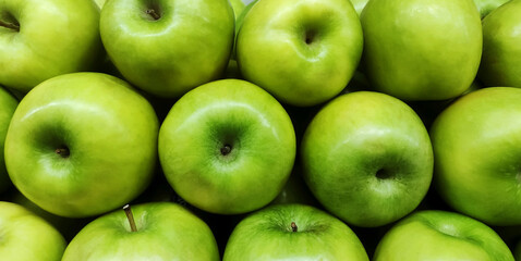 Fresh unripe green apples as background

