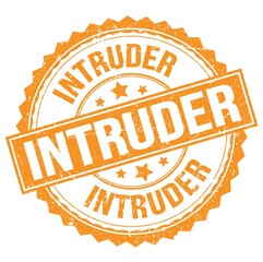 INTRUDER text on orange round stamp sign