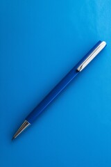 A sleek blue pen rests on a smooth, matching blue surface in artistic style.