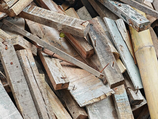 Pile of pieces of scrap wood blocks with nails