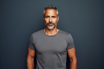 Fototapeta premium Portrait of a content man in his 40s donning a trendy cropped top in front of minimalist or empty room background