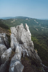 gray cliff above a valley in the mountains, steep precipice