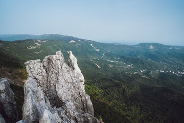 gray cliff above a valley in the mountains, steep precipice