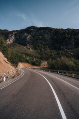 good asphalt road in the mountains on a sunny day, solid marking line, mountains of Georgia