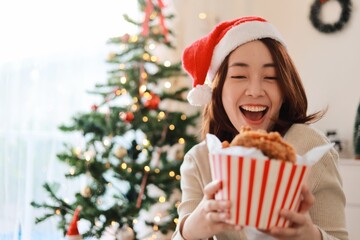 Beautiful Asian woman eating a crispy fried chicken in bucket 