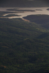 bird's eye view of mountain lake at sunset, winding lake among mountains