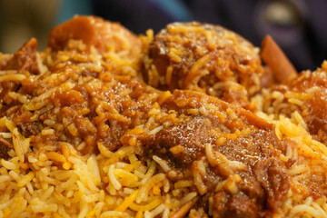 Spicy Lamb Biryani: A close-up of a steaming plate of  lamb biryani, showcasing the fragrant rice, tender lamb, and rich, flavorful sauce.