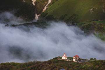 church against the backdrop of clouds in the mountains georgia
