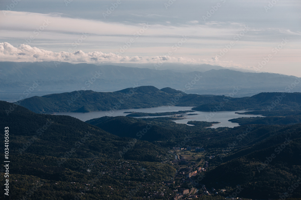 Wall mural bird's eye view of mountain lake at sunset, winding lake among mountains