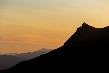 mountain ranges at sunset in the haze