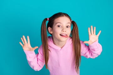 Photo portrait of lovely little girl stick tongue out dressed stylish pink garment isolated on...