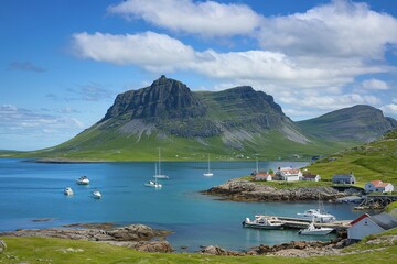 A coastal town nestled along a turquoise blue bay, surrounded by rugged mountains under a clear blue sky with fluffy white clouds