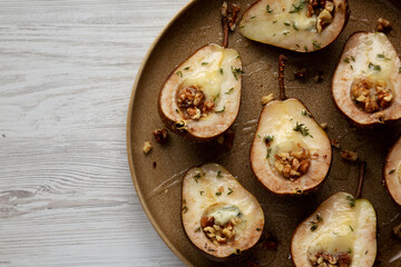 Homemade Blue Cheese Stuffed Pears with Honey, Thyme and Walnuts on a Plate, top view. Copy space.
