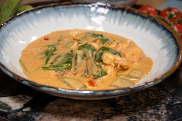 A bowl of delicious West African stew on a wooden kitchen work top