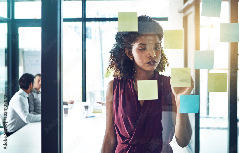 Poster getting hands in in growth strategies. shot of a young businesswoman having a brainstorming session 