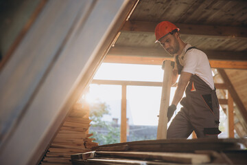 Fototapeta premium Process of construction new and modern modular house. Worker man in special protective uniform wear working on building development industry of energy efficient property.