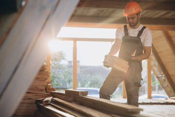 Process of construction new and modern modular house. Worker man in special protective uniform wear...