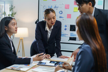 Team of business professionals is working together, analyzing financial data and developing a growth strategy for their company