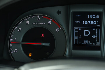 Empty fuel warning light in car dashboard. Fuel pump icon. gasoline gauge dash board in car with digital warning sign of run out of fuel turn on. Low level of fuel show on speedometer dashboard.