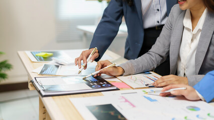 Business team working with financial data using digital tablet and document on desk in office