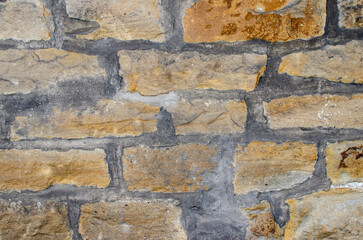 Old stone wall with weathered bricks