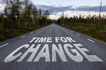 The words Road to Change in white letters on a street leading to a question mark, symbolizing the...