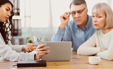 Geriatric Medicine. Close up of latina doctor showing elderly patients some information on a digital tablet, copyspace