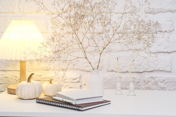 Fototapeta premium Create a Cozy Home Decor Atmosphere Using Notebooks and Natural Elements for Comfort.