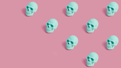 Seamless pattern of mint skulls on a pink background. Creepy concept. Halloween or Santa Muerte idea.