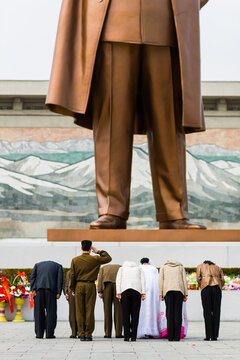 PYONGYANG, NORTH KOREA &ndash; MARCH 26, 2008 : young couples pay respect to Kim Il-Sung giant statue in Mansudae Grand Monument