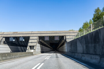 High-speed road tunnel view from a fast-moving car. Road and railway tunnel and blidge connecting...
