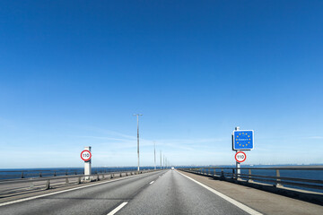 Highway road to Denmark with a sign about crossing the border of Denmark. High quality photo