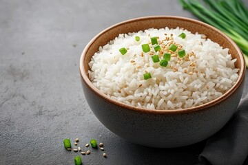 Soft, fluffy Thai jasmine rice served in a simple, elegant bowl with a sprinkle of sesame seeds and sliced green onions on top
