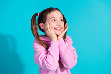 Photo portrait of lovely little girl look empty space dreamy dressed stylish pink garment isolated on aquamarine color background