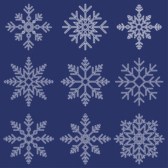 Fototapeta premium Set of winter snowflakes icons. Vector white snowflakes isolated on dark blue background.