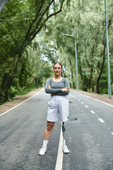 A young woman with a prosthetic leg confidently exercises outdoors, embracing the vibrant surroundings.