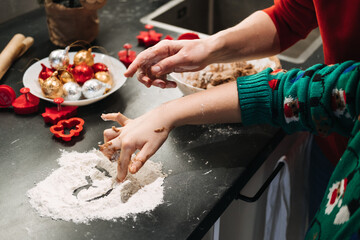 Child drawing a heart in flour, Christmas baking, holiday traditions, festive kitchen activities, family bonding, creative play, Christmas preparations.