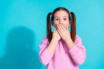 Photo portrait of pretty little girl cover mouth frightened wear trendy pink outfit isolated on...