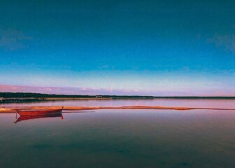 Serene landscape featuring a calm lake with a small wooden boat moored along a sandy shoreline. The...