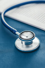 Stethoscope on blue surface with document