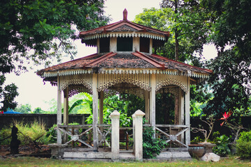 Obraz premium Traditional Gazebo Surrounded by Lush Greenery