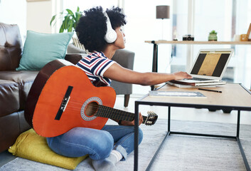 Woman, song and laptop with guitar at home for music, production or hobby performance. Girl,...