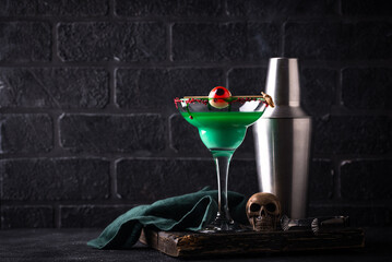 Haunting green Halloween cocktail with skull