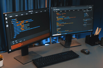 Programming code on computer two screens on desktop placing working desk showing intelligent...