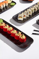 Elegant Sushi Roll Presentation Featuring Crab and Tobiko Roe with Vibrant Colors and Modern Composition