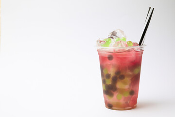 Tasty bubble tea in plastic cup on white background, space for text