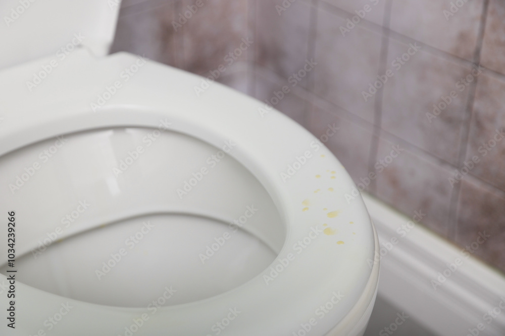 Sticker Urine drops on toilet seat in restroom, closeup