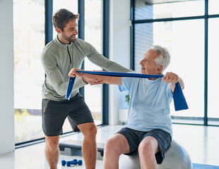 Fitness, old man or physiotherapist with exercise band for stretching, wellness or healing for injury. Rehabilitation, senior patient or male person with help for physiotherapy, arms recovery or ball